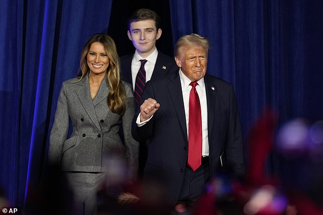 Republican presidential candidate, former President Donald Trump, accompanied by Melania Trump (left) and Barron Trump, arrives to speak at an election night watch party