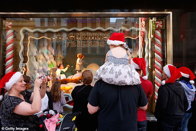 Famous unveiling of Myer's Christmas window display at Melbourne's CBD store will not go ahead (families are pictured at the iconic event in 2013)