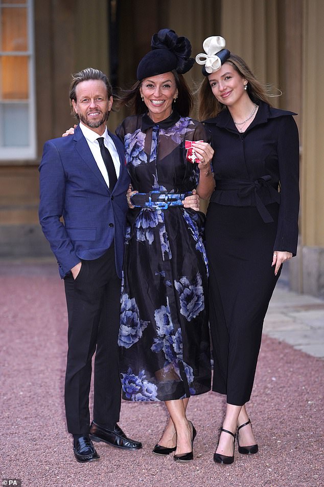 Davina told her Instagram followers this morning: 'I'm having it removed via a craniotomy through the top of my head here, and through the two halves of my brain, through the middle.' Pictured with her partner Michael Douglas and daughter Holly Robertson in January