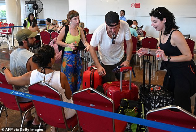 Major airlines including Qantas canceled several flights on Tuesday and Wednesday due to safety concerns that led to travel chaos (photo of stranded travelers in Bali)