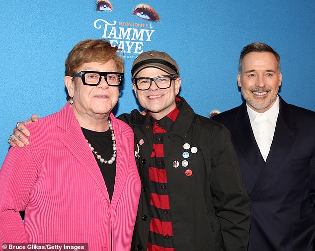 Elton (L) joined husband David (R) and Tammy Bakker's son Jay (C) on the red carpet