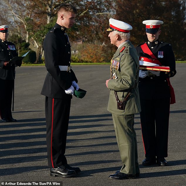 The King awards Marine Joseph Ryan the Commando Medal during a visit to the Commando Training Center Royal Marines