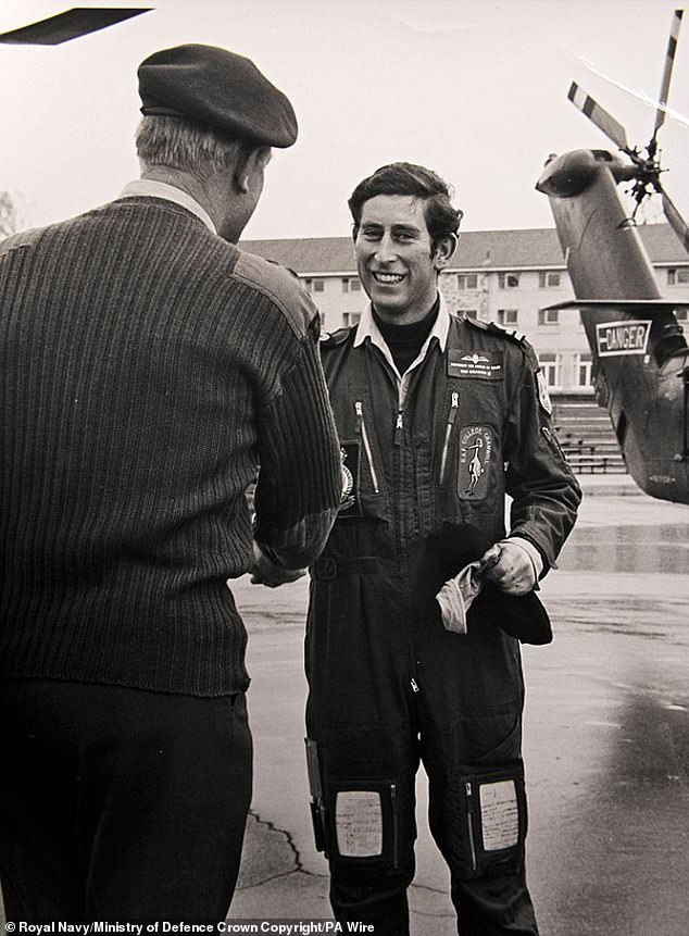 King Charles III, then Prince of Wales, in his flying overalls after landing his Wessex V helicopter on the parade ground of the Commando Training Center Royal Marines