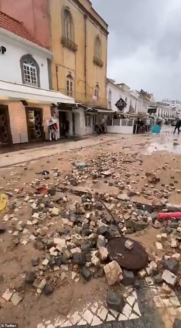 Separate clips show mud and debris strewn across the streets of the popular tourist destination after flooding subsided.