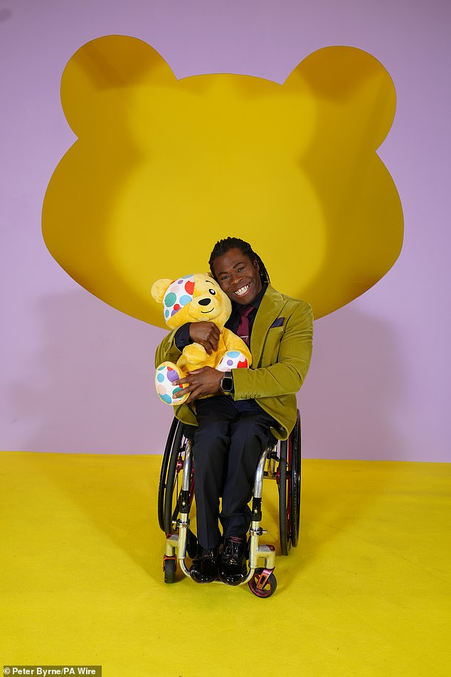 Ade Adepitan stood out in an olive green blazer and red tie