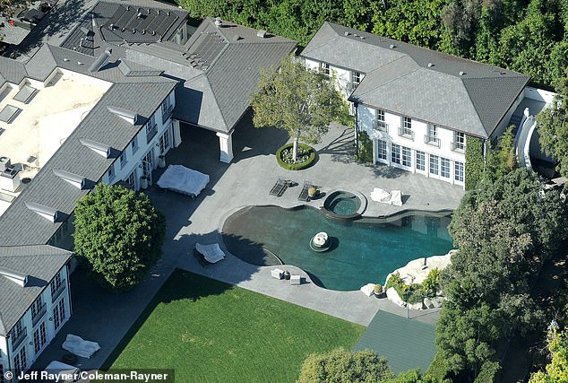 Diddy's $62 million estate in Holmby Hills is empty, with covered patio furniture and a pool maintained as suggested by the shallow brown bottom