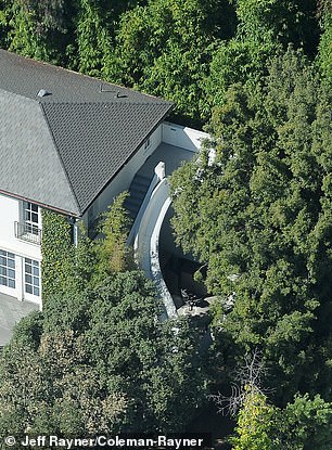 The pool slide runs from the side of the house to the underwater cavern below