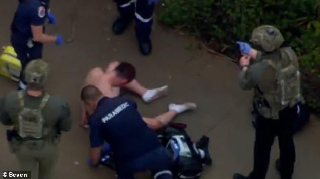 A shirtless man is treated at the scene by paramedics in Weir Views, Melbourne