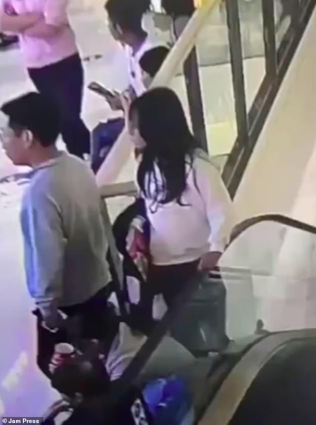 Gruesome CCTV footage of the incident shows the woman - who has not been named - leaning against the escalator before trying to hoist herself onto the moving handrail.