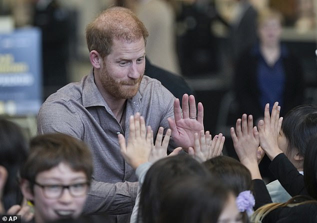 The Duke of Sussex seemed popular with the schoolchildren, who were all eager to share a high five with the royal family