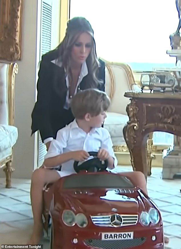 A smartly dressed Melania takes the opportunity to push her son around in his little red vehicle