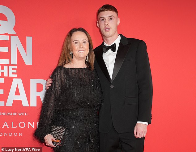 Palmer also posed for a photo with his mother Marie (left) at the chic event in London