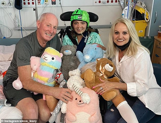 Leary (pictured with her parents Russ and Belinda) had to learn to walk again after a horrific cycling accident came incredibly close to her life in 2021