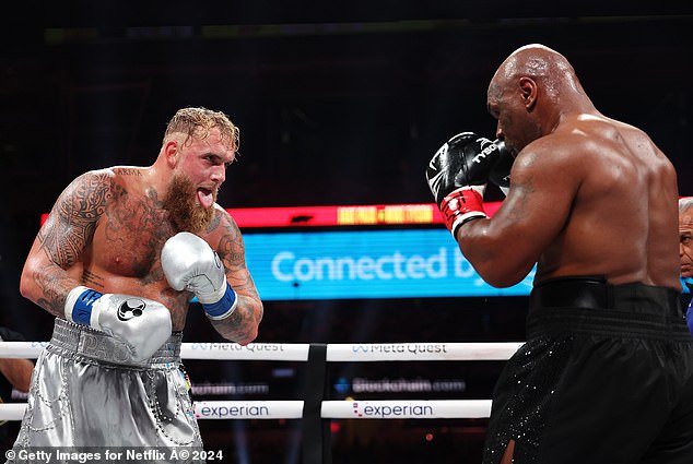 Jake Paul sticks his tongue out at Mike Tyson after taking a chin shot during his victory