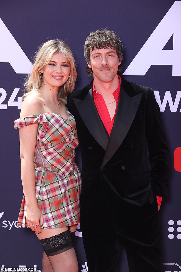 Tim, 43, and Lizzie, 28, couldn't keep their hands off each other as they walked the red carpet and officially confirmed their relationship with Daily Mail Australia