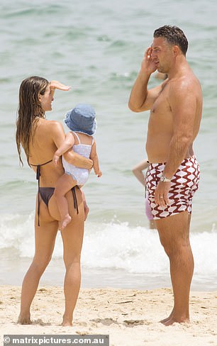 Little Robbie looked as cute as a button in a blue terry bucket hat and a cute sky blue swimsuit