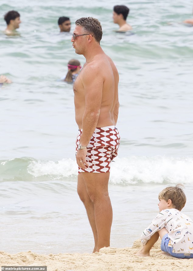 Sam wore red and white striped board shorts that ended at Sam's toned thighs