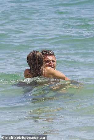 The loved-up couple wasn't afraid to pack on the PDA in the surf and happily canoodled as the waves lapped against their bodies