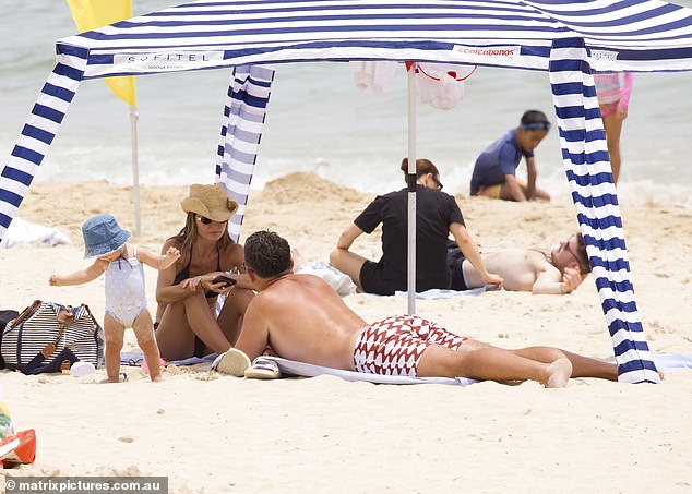 After the swim it was time for some relaxation, with the family retreating under the shade of a blue and white striped beach pergola