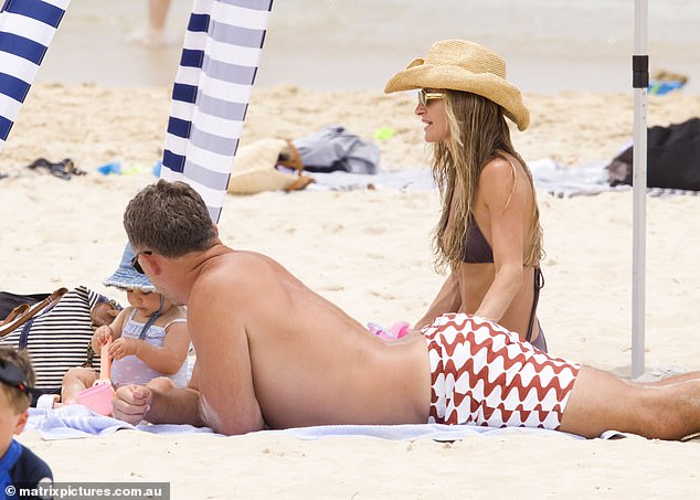 Lying with their backs to the sun, Lucy and Sam happily worked on their tans and relaxed in the sand