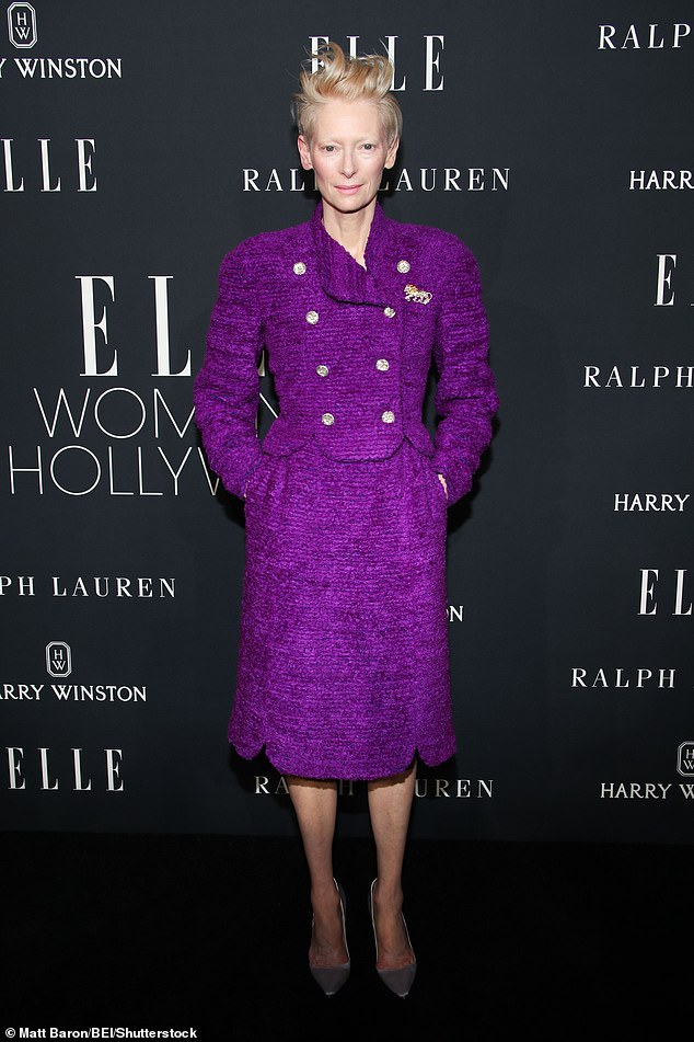 Tilda Swinton stood out in a striking purple tweed jacket with shiny gold buttons and a matching pencil skirt