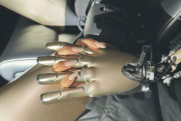 In another shot, Kim and the robot were seen holding hands in the luxury electric vehicle