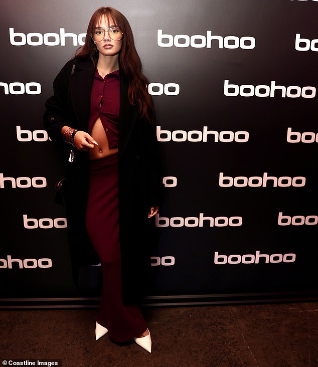 Daisy showed off her toned midriff in a burgundy co-ord which she paired with white stilettos and a long coat