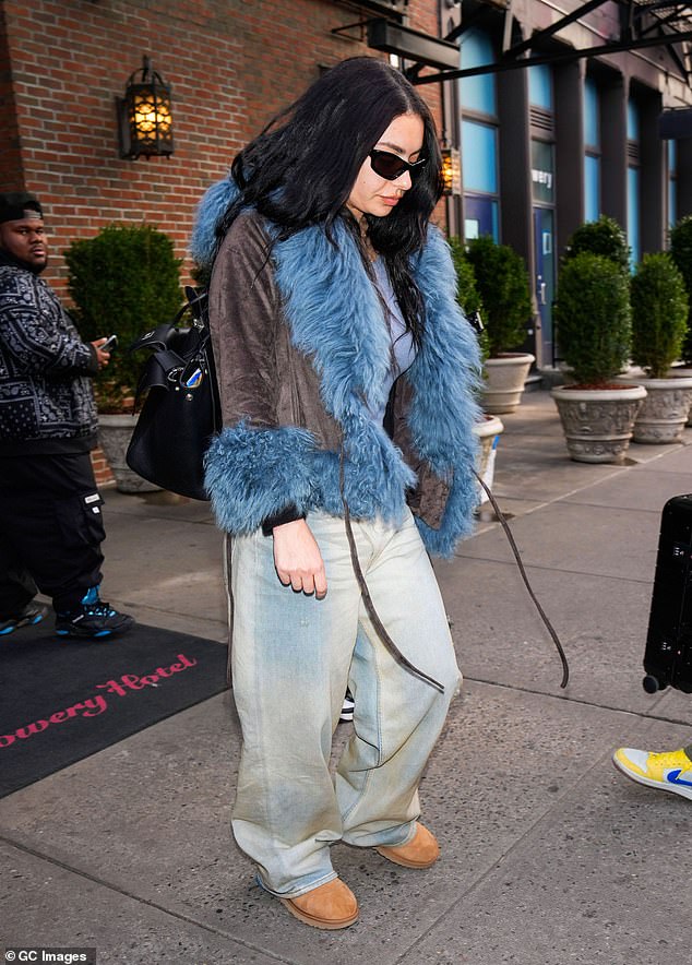 The 32-year-old singer, dressed in a brown jacket with a blue faux fur lining, wore them with wide-leg jeans in a light wash