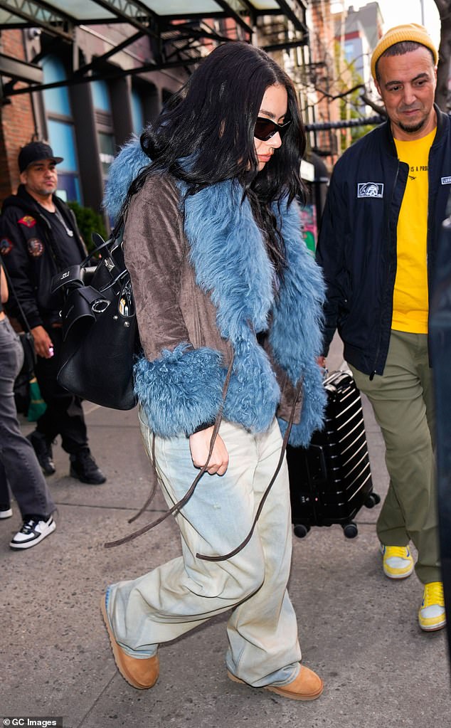 The Brat hitmaker also wore a pair of brown boots and a light blue top as she enjoyed her trip to the Big Apple