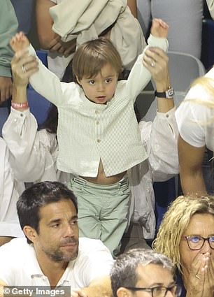 One last time! Rafa Jr. holds his hands up as his father enters the court