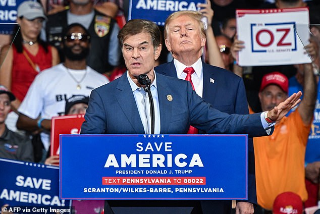 Mehmet Oz, who ran for the US Senate, speaks as former US President Donald Trump stands behind him