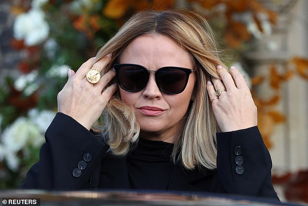 Kimberley shielded her eyes with sunglasses as she walked into the church