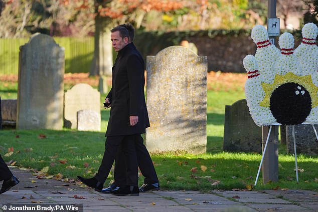 Scott Mills, who was unveiled yesterday as the new presenter of the Radio 2 Breakfast Show, walks past a floral display with bowling pins and a ball. This is a nod to Payne's love of bowling, which Ms Cassidy said he did four times a week