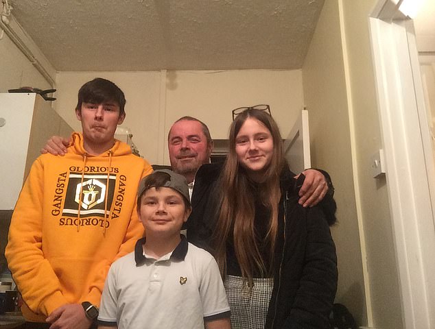 Mr Winchester (centre back) pictured with his daughter and two sons