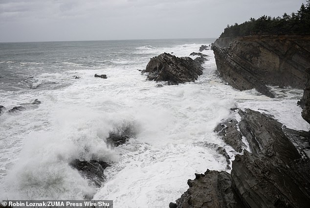 Storm surge crashes onto southwestern Oregon's rocky coastline as a bomb cyclone barrels toward the West Coast on November 19