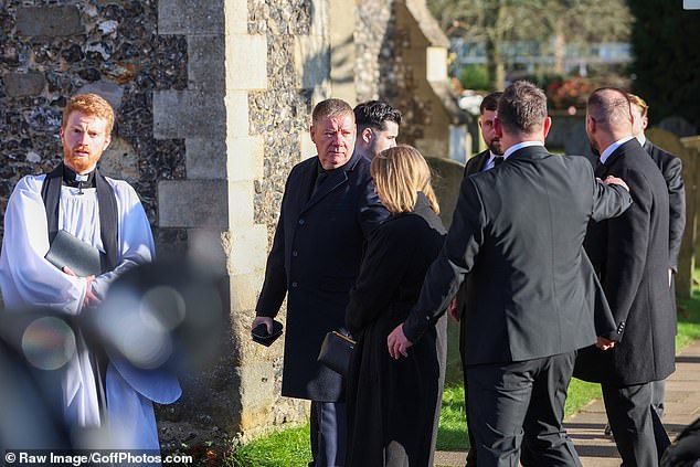 Liam Payne's father Geoff and mother Karen stand outside the church ahead of today's funeral