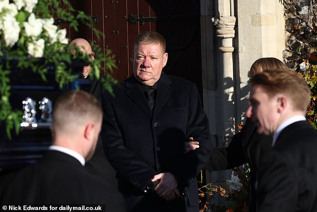 Liam Payne's father Geoff stands outside the church today for his son's funeral