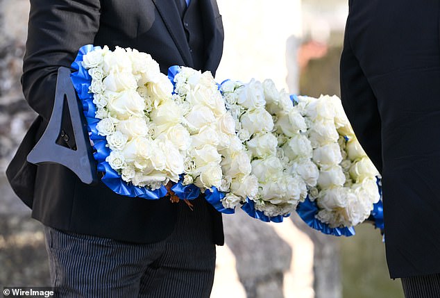 A floral tribute that spells the word "Dad" at the funeral