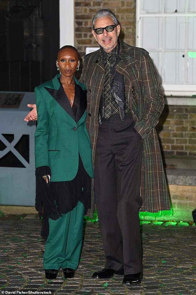 Jeff, who plays The Wizard, smiled for a photo with Cynthia, who stunned in a green and black suit