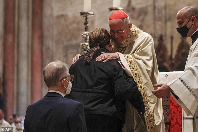 Acutis's parents, Antonia (front) and Andrea (back) are greeted by Cardinal Agostino Vallini during the beatification ceremony in Assisi, central Italy, in October 2020