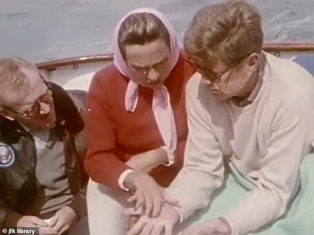 Among those in the film was JFK's close friend, Red Fay (left), who initially insisted he was the only one killed in the film. His wife is seen giving palmistry to the then president on board his yacht, the Honey Fitz