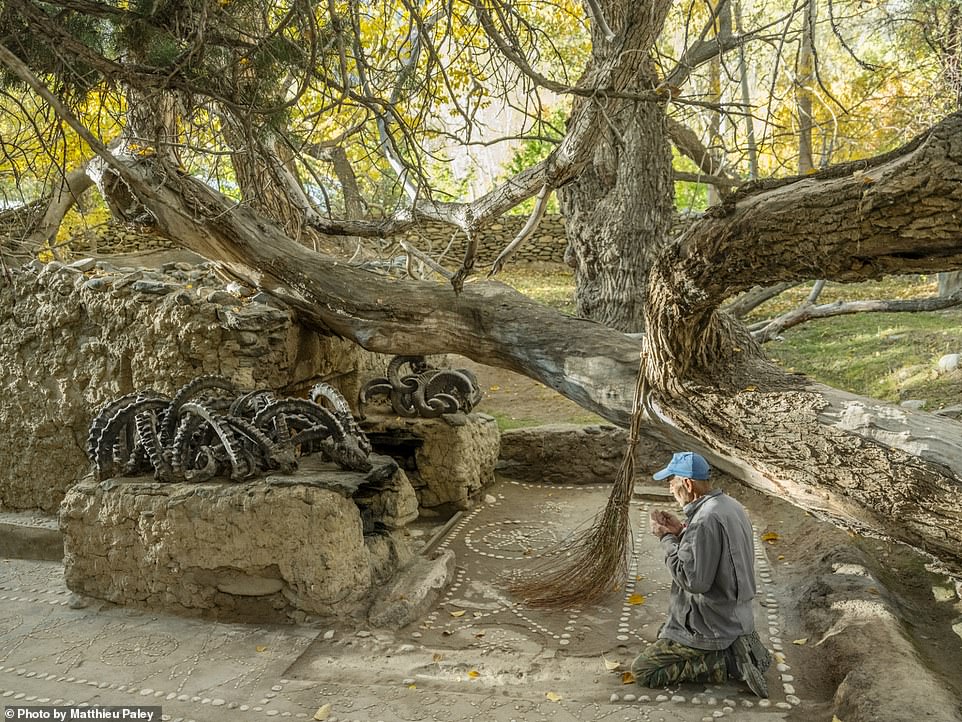 This thought-provoking image shows a shrine in an area with a rich history of animism, Zoroastrianism and Buddhism, maintained by local Wakhi people, who are Ismaili Muslims. Nat Geo explains that a tree that fell years ago on the shrine's grave, decorated with horns of ibexes and sheep, was left in place as custom dictates