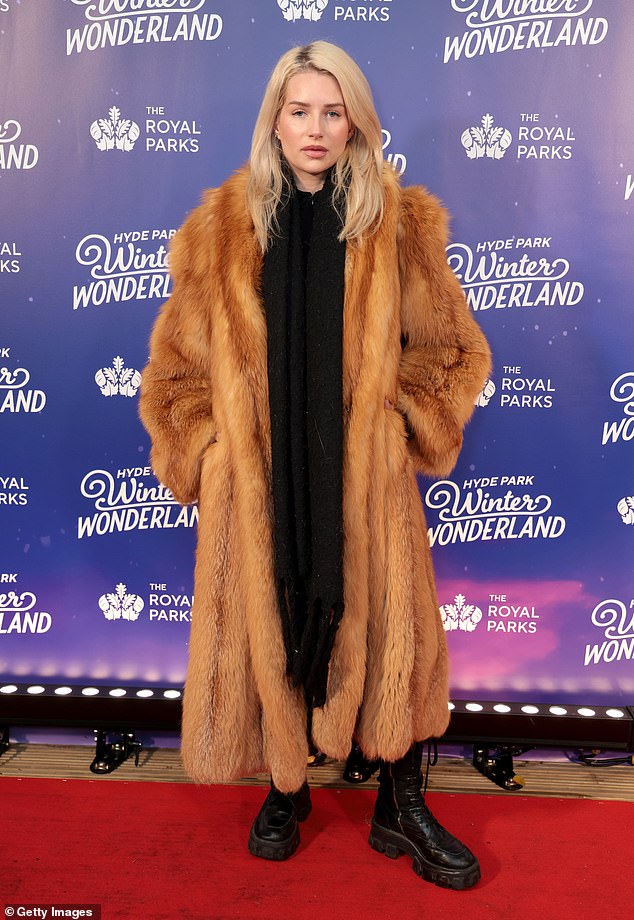 The model looked chic as she wore a red, ankle-length fur coat on the opening night of the festive event