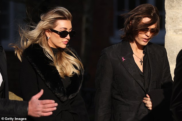 Kate, wearing a long black coat with fur trim and sunglasses, looked somber as she walked into the church with her friend