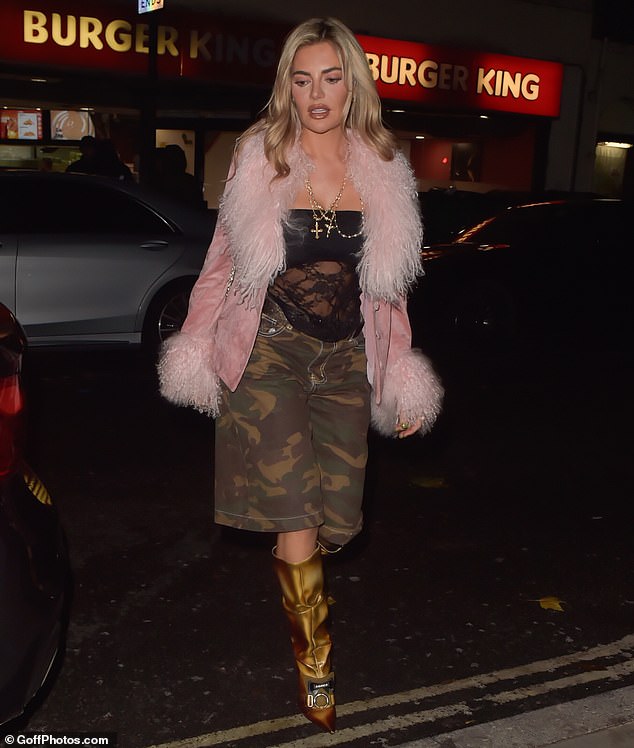 Megan stood out in loose-fitting camouflage shorts and a sheer lace top on her latest night out in London