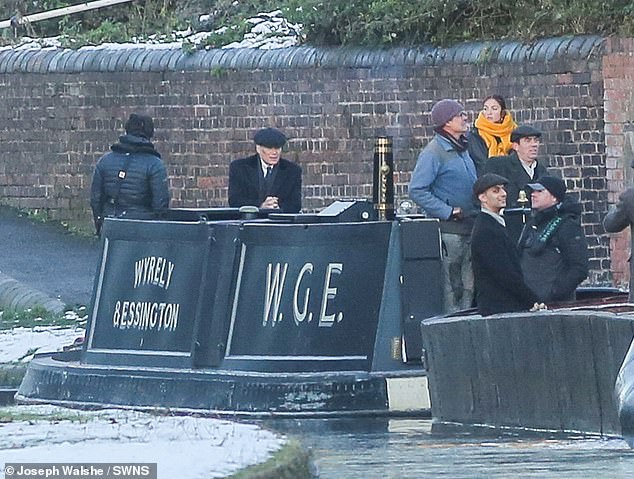 The Irish actor was dressed in Shelby's signature overcoat and Baker Boy cap as cameras rolled during an on-location shoot at Dudley Canal in Bumble Hole and Warrens Hall Nature Reserve