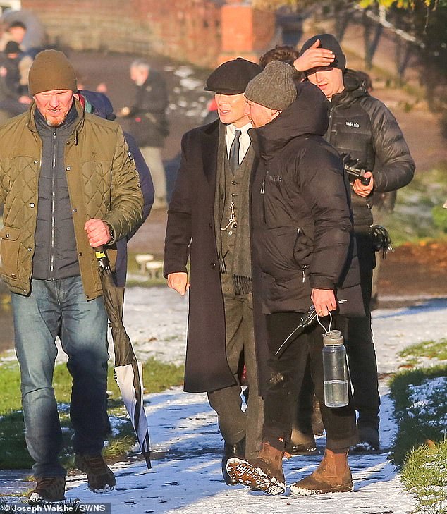 He was surrounded by crew members as he walked across the canal between takes on Wednesday