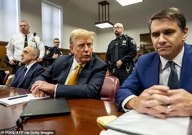 Donald Trump, sitting with attorneys Emil Bove (L) and Todd Blanche (R), attends his trial for allegedly covering up hush money payments related to extramarital affairs, at Manhattan Criminal Court in New York City, on May 21, 2024