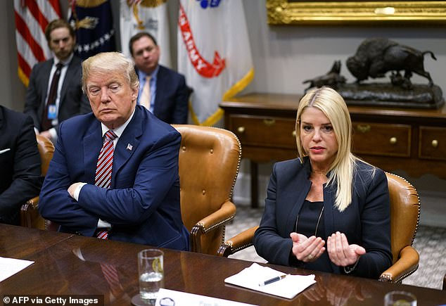 U.S. President Donald Trump (L) watches as Florida Attorney General Pam Bondi speaks during a meeting with state and local officials on school safety in the Roosevelt Room of the White House on February 22, 2018 in Washington, DC