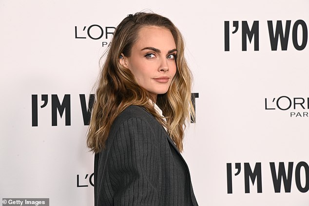 Delevingne's wavy blonde hair was swept to one side, creating a voluminous look